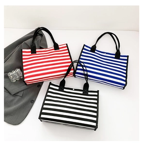 Detailed top view of three large canvas tote bags with red, blue, and black stripes