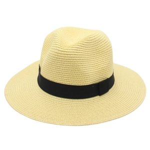 Detail of light beige woven Panama hat with a classic black ribbon band decoration