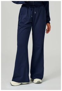 Detail of navy blue wide-leg sweatpants with adjustable drawstring waist and side pockets