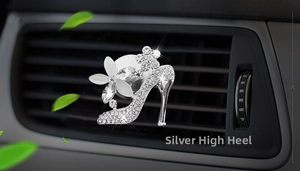 Close-up of a silver high heel car air vent clip with sparkling rhinestones and floral detail