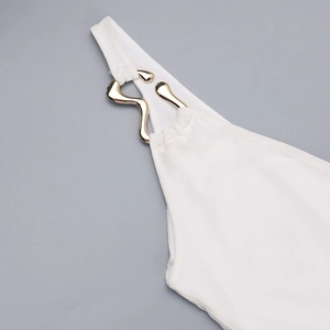 Detail view of the white mesh dress featuring a golden snake-shaped metal buckle ornament