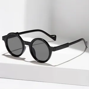 Retro round frame sunglasses with thick black frames and dark grey lenses for women