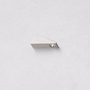 Close-up of polished silver stainless steel triangle pendant with threaded hole detail