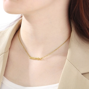Detail of 18K gold plated mami script necklace with heart charm on a model