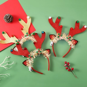 Detail showing festive LED reindeer antlers with colorful pom-poms and holly decorations
