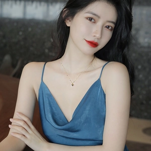 Elegant 18K gold plated heart pendant necklace worn by model on blue silk dress