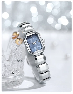 Close-up of GEDI silver watch featuring octagonal case and blue mother-of-pearl dial