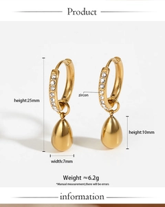 Detailed view of gold stainless steel earrings with zircon inlay and teardrop pendants