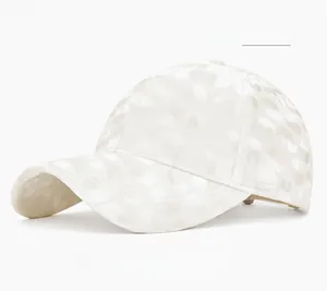 Detailed close-up of beige polka-dot corduroy baseball cap texture with velvet finish