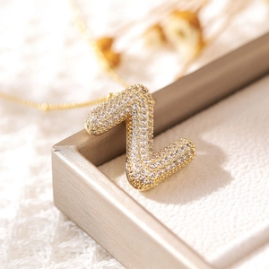 Detailed view of a gold-plated letter Z pendant with zircon in a premium jewelry box