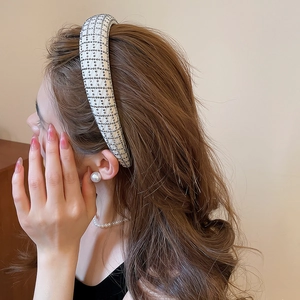 Detail of grid pattern headband featuring silver rhinestones on thick mesh fabric