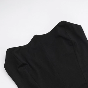 Detailed close-up of velvet splicing and stitching on the neckline of a black dress