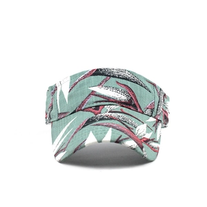 Detail of teal ethnic sun visor with abstract leaf print and textured cotton fabric