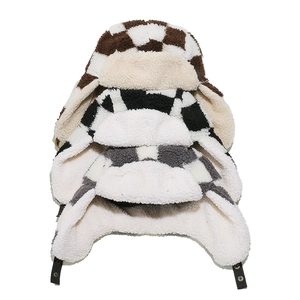 Detail of checkered trapper hats with thick fleece lining and adjustable buckle straps