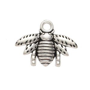 Macro shot of antique silver bee pendant with hollowed wing details and top hanging loop