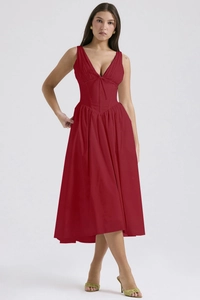 Close-up of deep red V-neck corset dress showing fitted waist and premium fabric texture