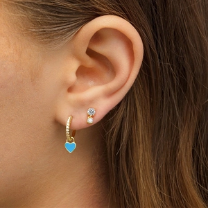 Detail of model wearing 18K gold-plated S925 silver hoop with light blue heart pendant