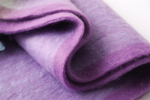 Close-up of soft purple faux cashmere scarf showing thick knit texture and gradient colors