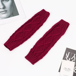 Close-up of wine red cable knit arm warmers with thick ribbed cuffs for winter