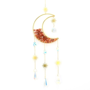 Detail of golden moon suncatcher with raw orange crystals and faceted glass pendants