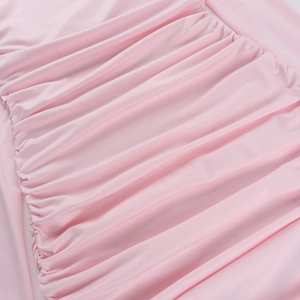 Detailed close-up of pink ruched fabric texture with elegant pleats and stretchy knit finish
