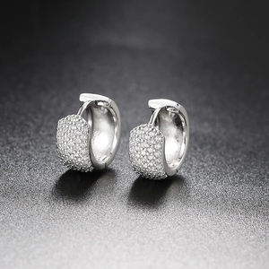 Macro detail of silver huggie earrings with five rows of micro-pave white zircon stones