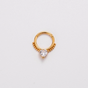 Detail of 16G gold stainless steel nose ring hoop featuring a heart zircon and beads