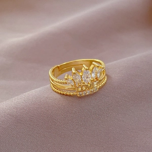 Detailed macro view of golden crown ring with crystal stones and LOVE engraving
