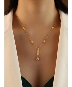 Elegant 18K gold-plated Y-necklace with star pendant shown on model in white blazer