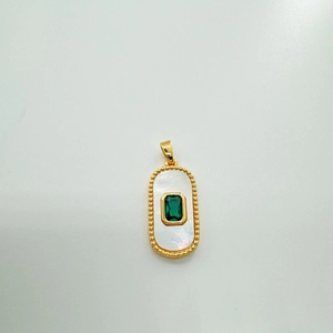 Detailed view of rectangular 18k gold plated shell pendant with green gemstone center