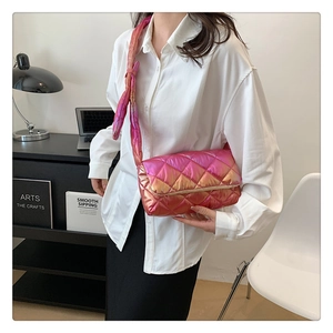 Close-up of pink gradient quilted crossbody bag with stylish knotted shoulder strap detail