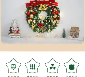 Close-up of Christmas wreath with red bows, gold bells, and warm glowing LED lights