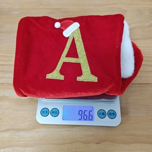 Dettaglio calza di Natale in velluto rosso con lettera A dorata e peso di 96,6 grammi
