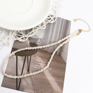 Elegant natural pearl necklace with gold adjustable chain and lobster clasp on magazine
