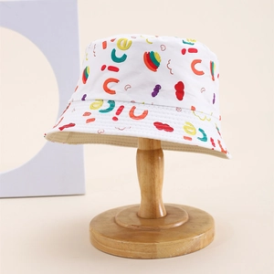 Close-up of colorful embroidery letters on a white cotton sun hat for children
