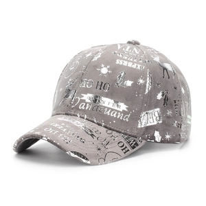 Detail view of grey suede baseball cap with silver reindeer and snowflake holiday prints