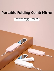 Detail of light pink 3-in-1 folding travel mirror and comb with a metal chain