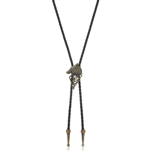 Detailed close-up of bronze wolf head pendant and dark brown braided leather bolo tie