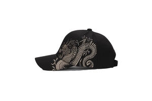 Close-up of golden dragon pattern embroidery on a stylish black baseball cap