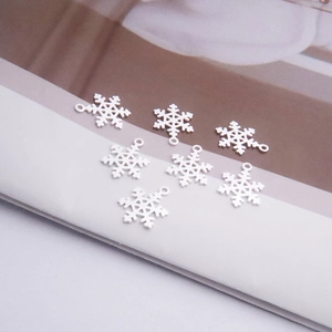 Macro detail of seven S925 sterling silver snowflake charms for DIY jewelry making