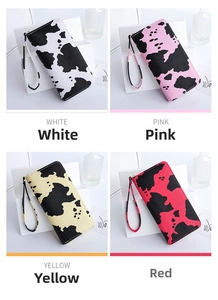Detail of cow print long zipper wallets in black, pink, yellow, and red with wrist straps