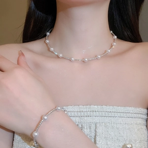 Detailed view of pearl and rhinestone necklace set with elegant sparkling finish