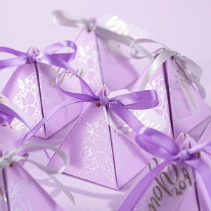 Elegant purple pyramid wedding favor box with floral patterns and satin ribbon bow