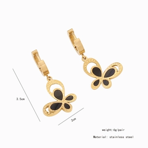 Detail view of gold stainless steel earrings with black butterfly pendants and size labels