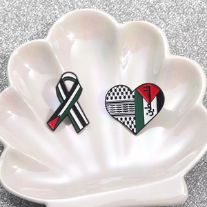 Palestine flag themed enamel pins set with heart and ribbon shapes on shell base