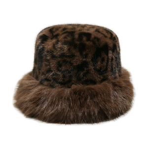 Macro detail of plush faux fur texture on a leopard print winter bucket hat for women
