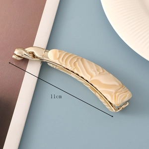 Detail of 11cm marble pattern acetate hair claw clip with golden metal components