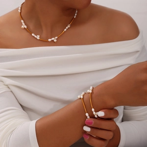 Elegant French gold titanium necklace and bracelet set with irregular white pearls