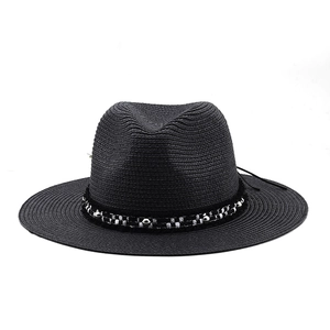 Close-up of black straw fedora with patterned band and decorative metallic beads