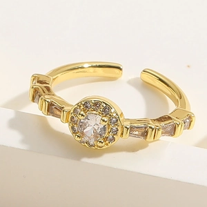 Macro shot of gold adjustable ring with circular zirconia and rectangular side gems